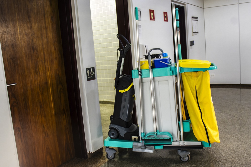 First Facility Services janitorial employee cleaning a commercial interior